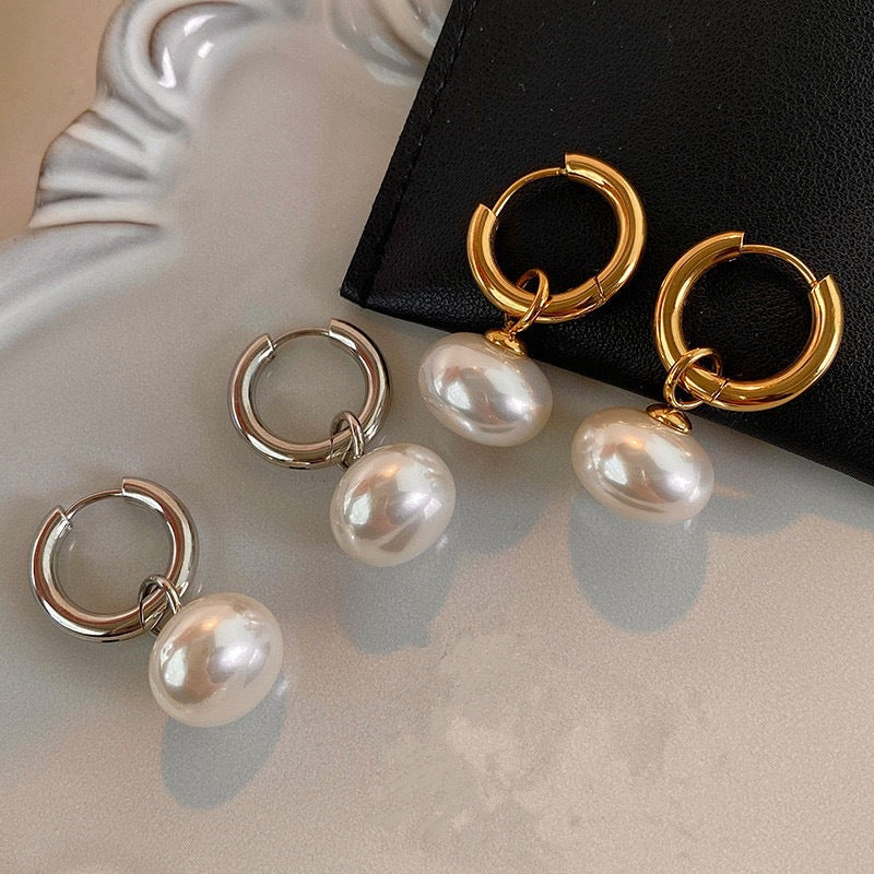 Stainless steel earrings with flattened round pearl-like studs