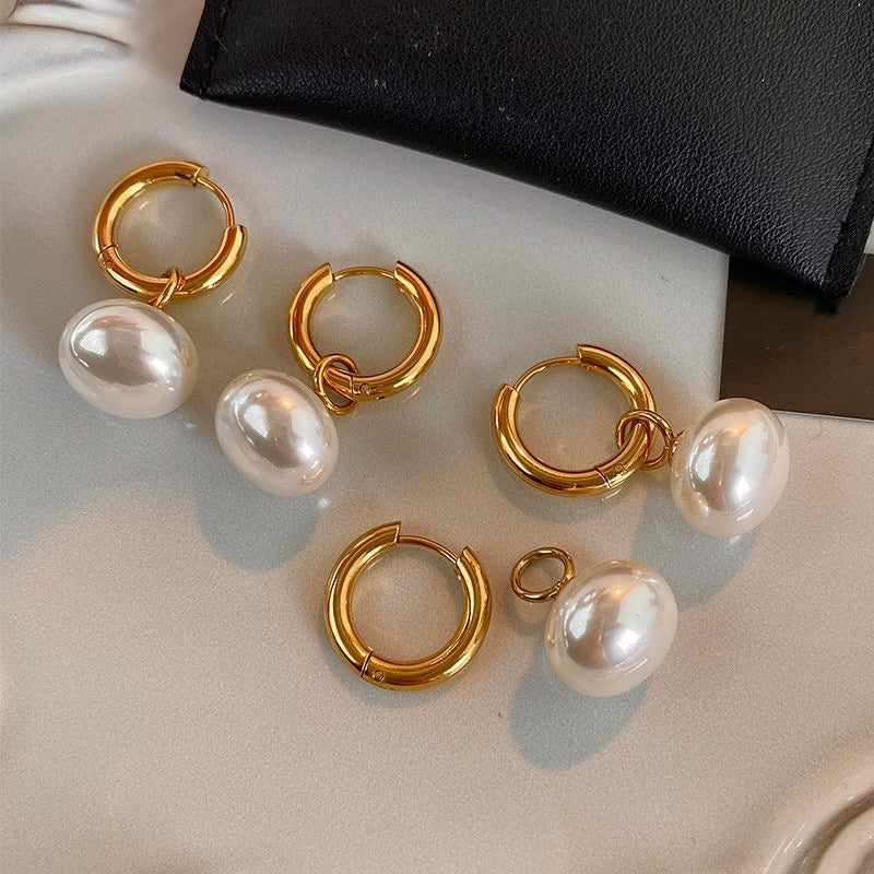 Stainless steel earrings with flattened round pearl-like studs