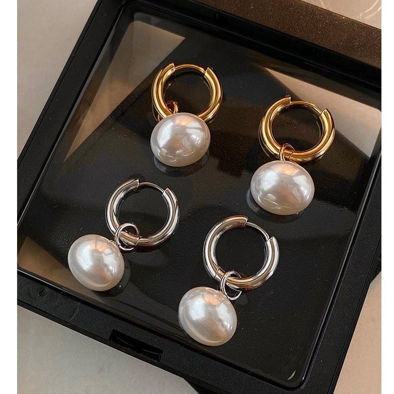 Stainless steel earrings with flattened round pearl-like studs