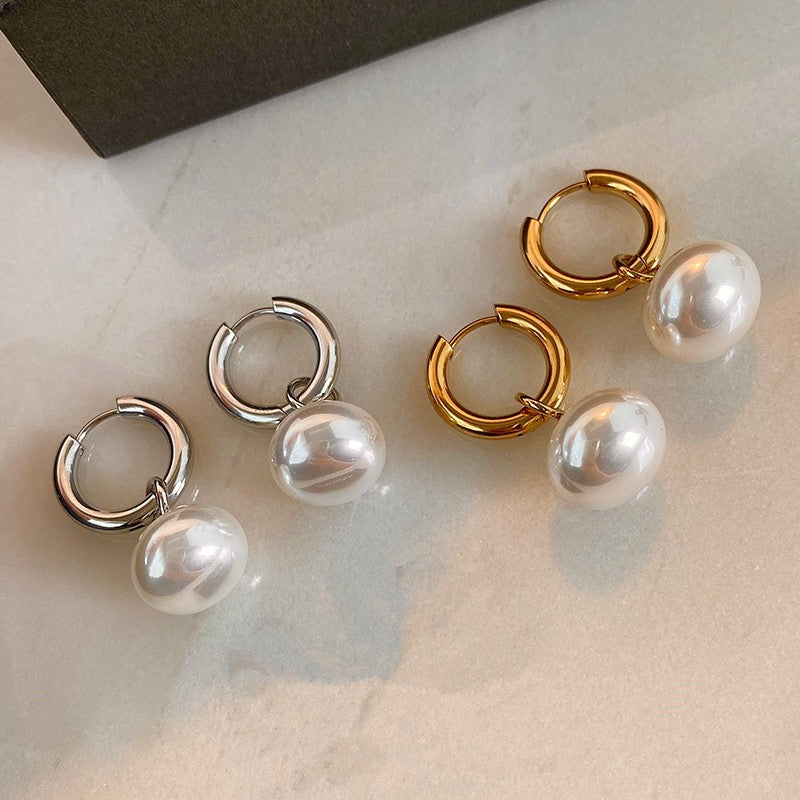 Stainless steel earrings with flattened round pearl-like studs