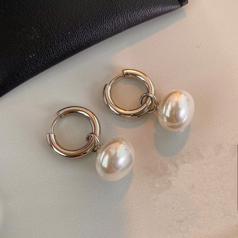 Stainless steel earrings with flattened round pearl-like studs