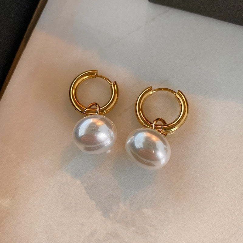 Stainless steel earrings with flattened round pearl-like studs